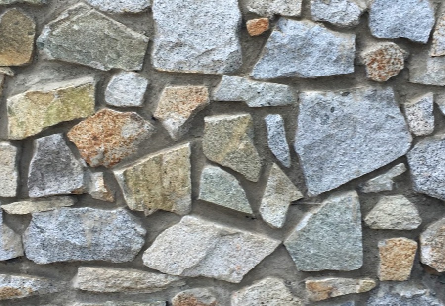 Rubble-stone foundation joints being repointed on an older building